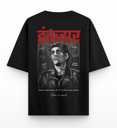 Black oversized t-shirt with a graphite-style drawing of a man, Hindi text, and bold red print.