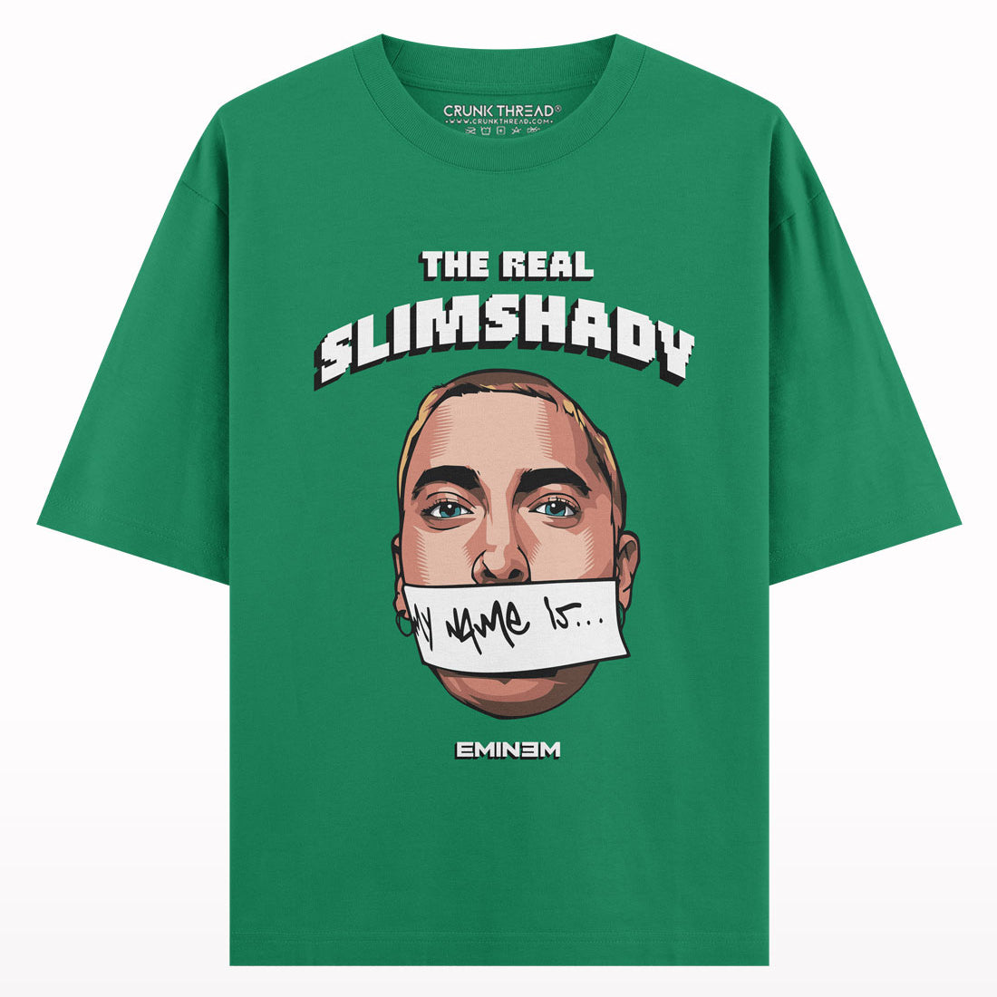Green oversized t-shirt featuring illustrated face, 'The Real Slim Shady' text, and graphic accents